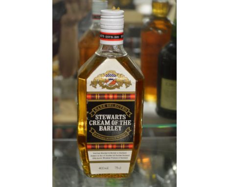 A bottle of Stewarts cream of the barley blended scotch whisky.
