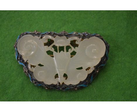A Chinese jade and enamelled silver brooch in the form of a butterfly.