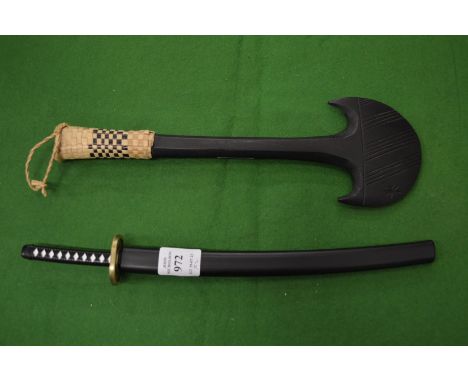 A miniature Samurai sword and another item.