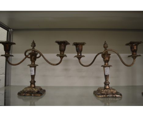 A pair of plated candelabra.