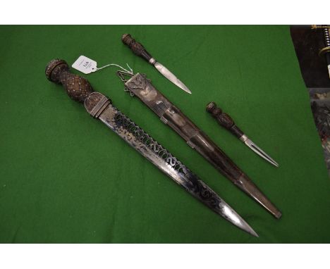 A very good Scottish dirk with a subsidiary knife and fork in a white metal mounted scabbard, the terminals of each item moun