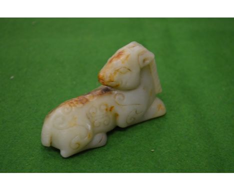 A small carved jade model of a goat.