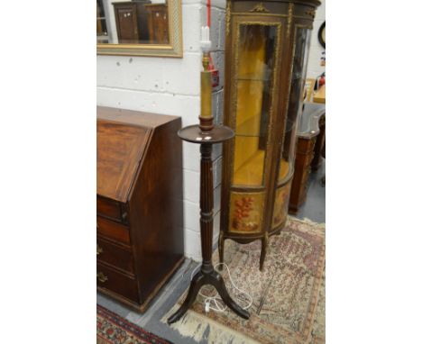 A mahogany torchere style floor standing lamp.