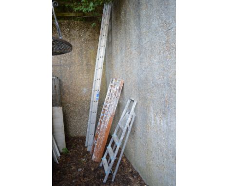 An aluminium two section ladder, a wooden three section ladder and a step ladder.