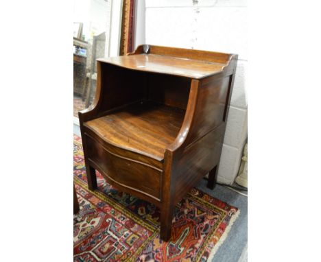 A George III mahogany commode with rising top, lifting seat on square legs.