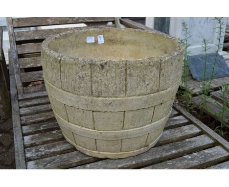 A large reconstituted stone garden planter.