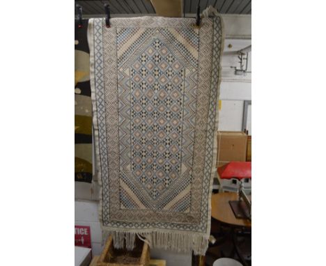 An ethnic tapestry style rug 195cm x 102cm.