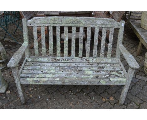 A weathered hardwood garden bench.