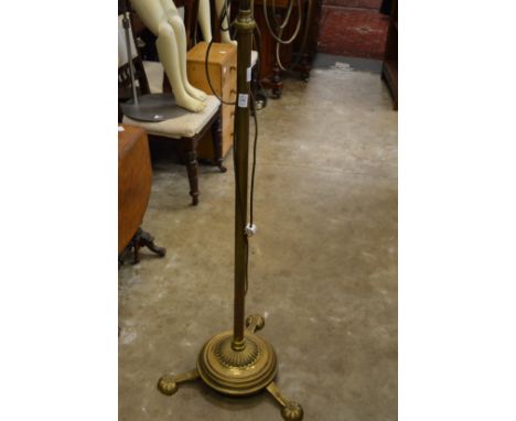 A brass floor standing lamp.
