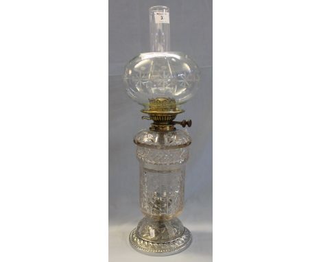 Brass double burner oil lamp with cut lead crystal glass reservoir and urn shaped base on domed support with metal mount, cle