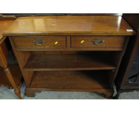 Reproduction oak hall side table with two frieze drawers and bookcase below on bracket feet.(B.P. 24% incl. VAT)