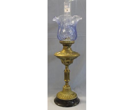 Early 20th Century brass double burner oil lamp with fluted brass reservoir and pedestal on ceramic base with coloured glass 