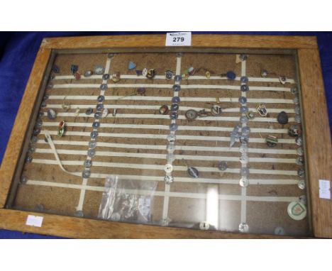 Wooden glazed cabinet containing assorted enamel football pins to include; international Brazil, Cyprus, Wales, Ireland, Germ