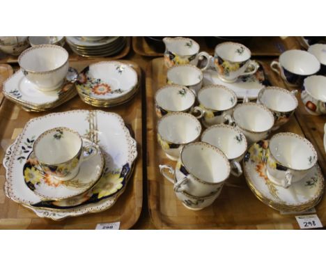 Two trays of Belle fine bone china, florally decorated, comprising: cups; saucers; side plate; sandwich plate; cream jug; sug