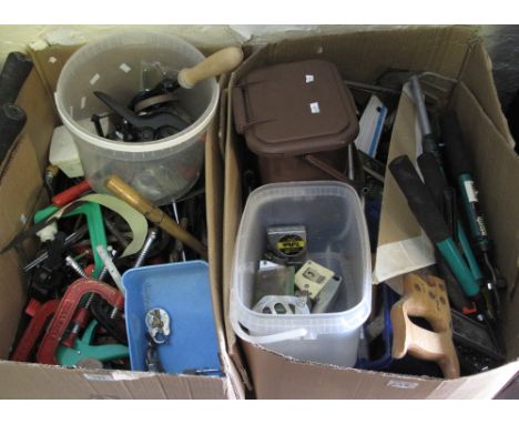 Two boxes containing a good assortment of hand tools including: saws; hammers; loppers; hand drill; carpenter's clamps; socke