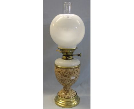 Early 20th Century brass double burner oil lamp with opaline glass reservoir on a transfer printed ceramic base with brass fo