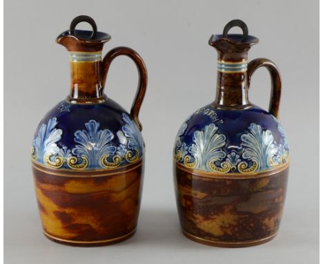Pair of Doulton Lambeth stoneware 'Scotch' decanters and stoppers in mainly brown and blue glazes, with tubelined decoration 