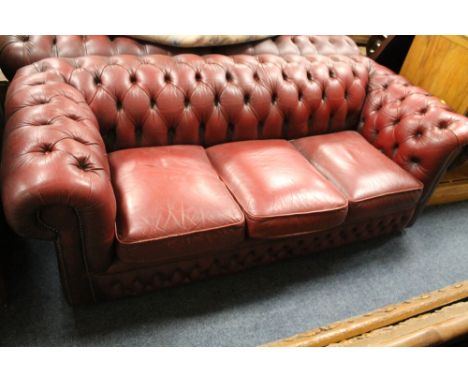 AN OXBLOOD CHESTERFIELD SOFA WITH TWO ARMCHAIRS A/F