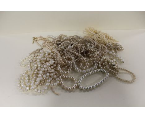 A BAG OF FAUX PEARL NECKLACES 