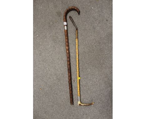 A SILVER BANDED BAMBOO RIDING CROP TOGETHER WITH A SILVER BANDED WALKING STICK 