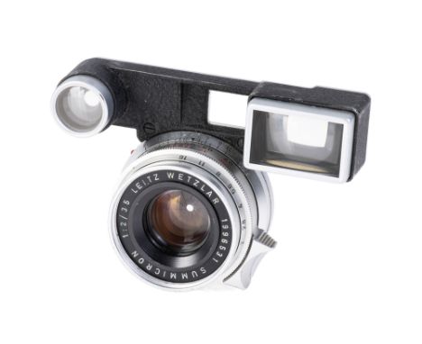 A Leitz Summicron f/2 35mm Lens, 1963, chrome, serial no.1996531, with ocular attachment for M3 camera, body, G, elements, F,