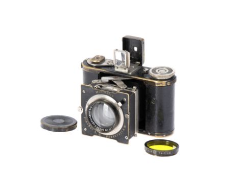 A Plaubel Makinette Strut Camera, 1931, black, with Plaubel Supracomar f/2 45mm lens, serial no. 92956, body, G, shutter work