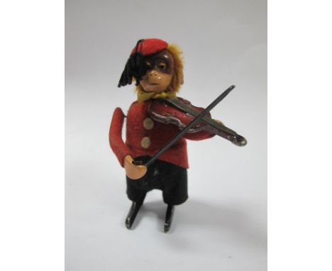 A Mid XX Century Clockwork Monkey, playing a violin by Schuco of Germany.