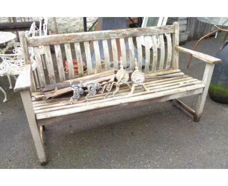 A 1.5m weathered teak lathe back garden bench with slatted seat and flanking armrests - by Alexander Rose