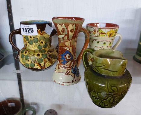 A Baron Barnstaple Pottery vase with sgraffito floral decoration on a brown ground and a C.H. Brannam Barnstaple small jug of