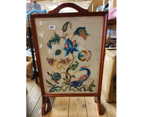 A vintage firescreen with framed and glazed embroidered panel