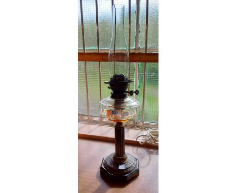 A Victorian oil lamp with cut sided clear glass reservoir, set on brass pedestal plinth with glass base - sold with clear gla