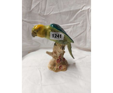 A Beswick model depicting a parrot seated on a tree trunk - Model 930