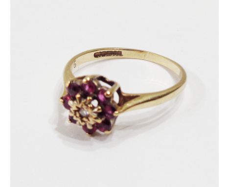 A 375 (9ct.) gold ring, set with tiny diamond within a small ruby border - size K 1/2