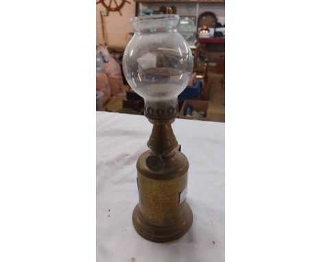 A vintage French Lampe-Olympe handheld oil lamp with glass shade and name plaque to front