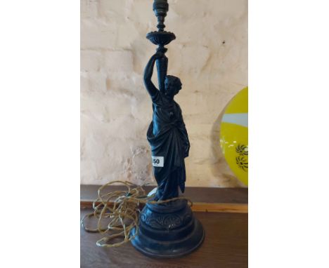 An antique spelter figural table lamp depicting a classical maiden, set on wooden plinth with black painted finish