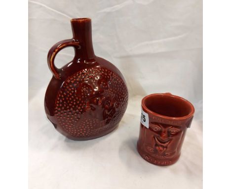 A Devonmoor pottery full/empty novelty face mug with red glaze finish - sold with a similarly decorated flask