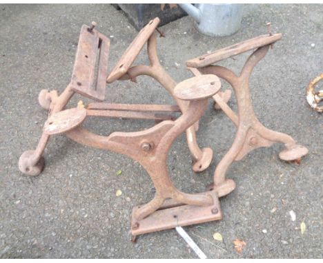 A set of four late 19th Century cast iron plank bench supports, each with brace support and two swept disc feet