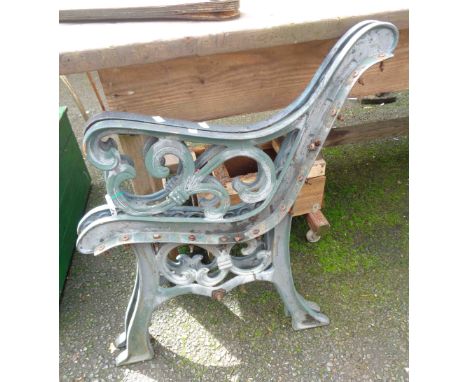 A pair of green painted cast iron bench ends
