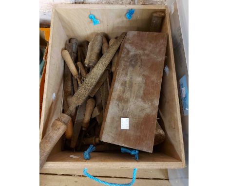 A wooden box containing a quantity of vintage tools including rasps, files, etc.