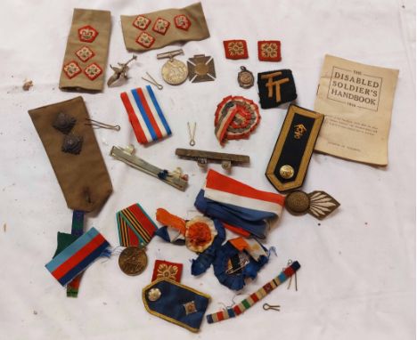 A bag containing a quantity of military patches, epaulettes, medallions, etc. - sold with a copy of The Disabled Soldiers Han
