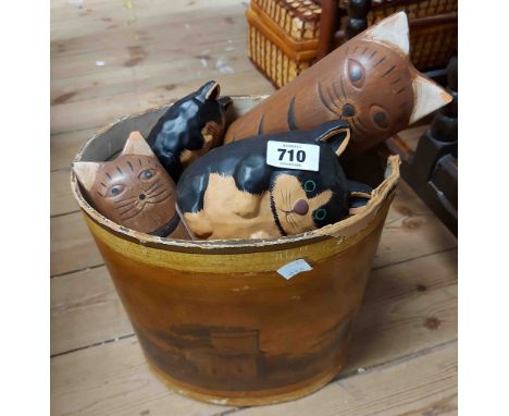An old pressed cardboard waste paper bin with classic print scene containing a quantity of carved wood and ceramic cat orname