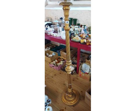 A reproduction giltwood standard lamp with decorative pillar and circular base