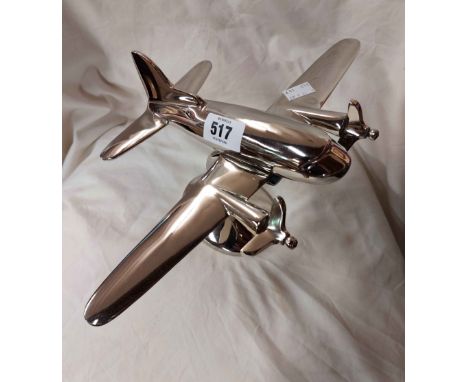 A modern plated metal model of a twin engine aeroplane