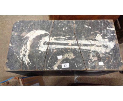 A black painted wooden lift-top tool chest containing a quantity of tools including planes, pincers, small vice, etc.