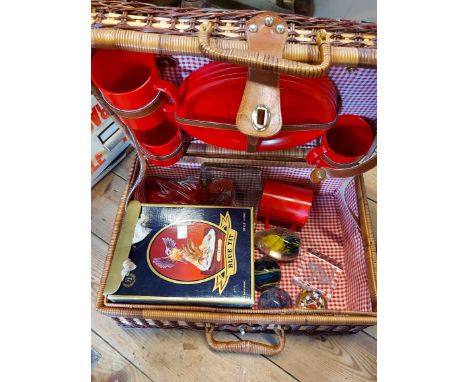 A wicker picnic hamper containing a small quantity of collectable items including paperweights, blue tit figurine, etc.