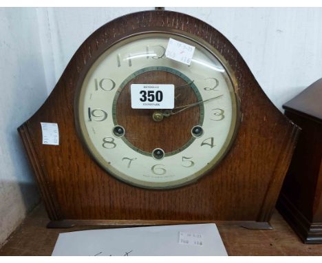 A vintage Smiths stained oak cased mantel clock with eight day chiming movement