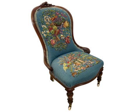 Victorian mahogany framed nursing chair, cresting rail decorated with applied carved roses and foliage, back and sprung seat 