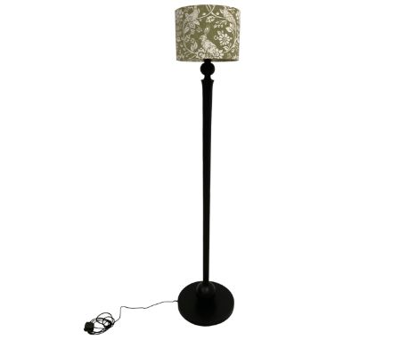 Contemporary black finish standard lamp, on turned stem and circular base, with green shade decorated with hares and pheasant