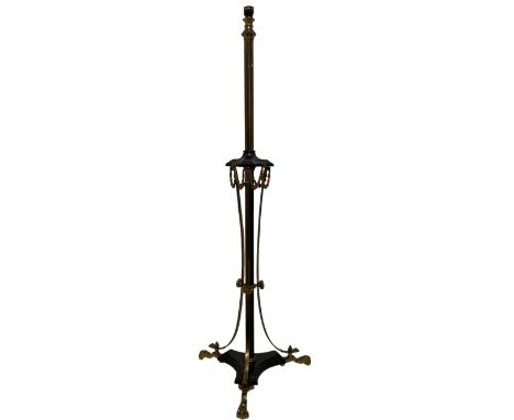 Victorian brass and ebonised metal standard lamp, the triform tier decorated with gilt festoons and downswept uprights, raise