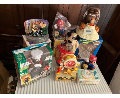 Eight novelty clocks including 2 super Mario clocks one in box, 1 Chicken Run "Ginger s Escape" boxed, 1 x Carton of milk , 1